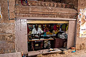 The great Chola temples of Tamil Nadu - The Sri Ranganatha Temple of Srirangam. The workshop of a tailor inside the gopura of the northern entrance. 